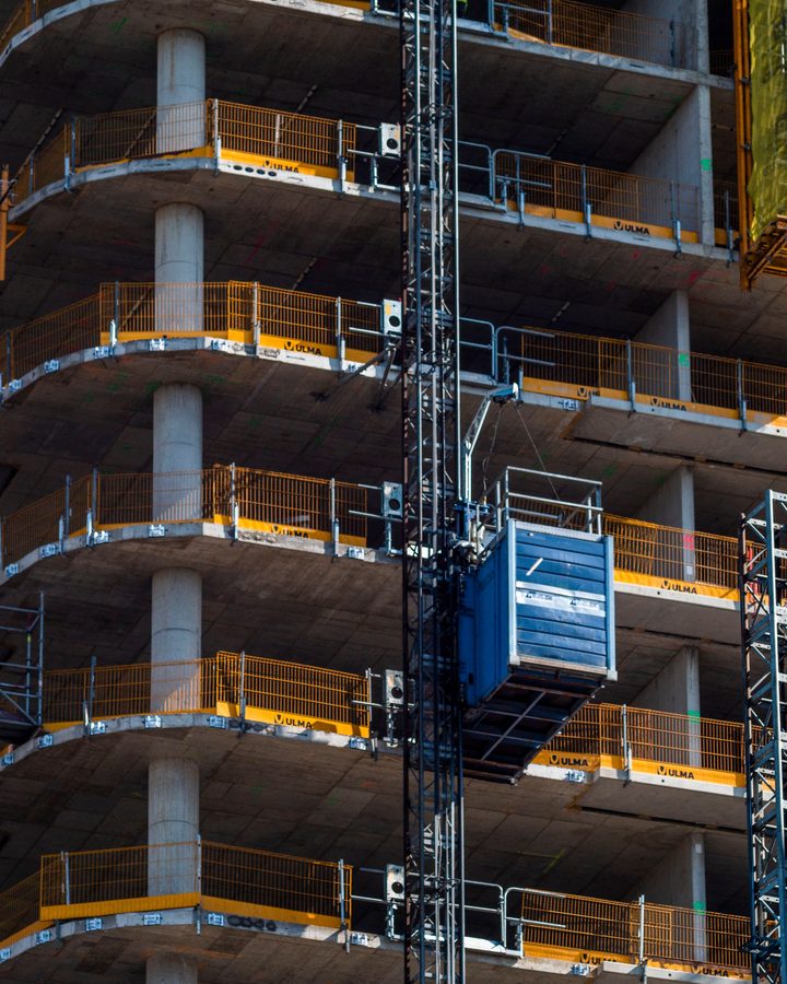 A structure under construction with hoists and formwork in place